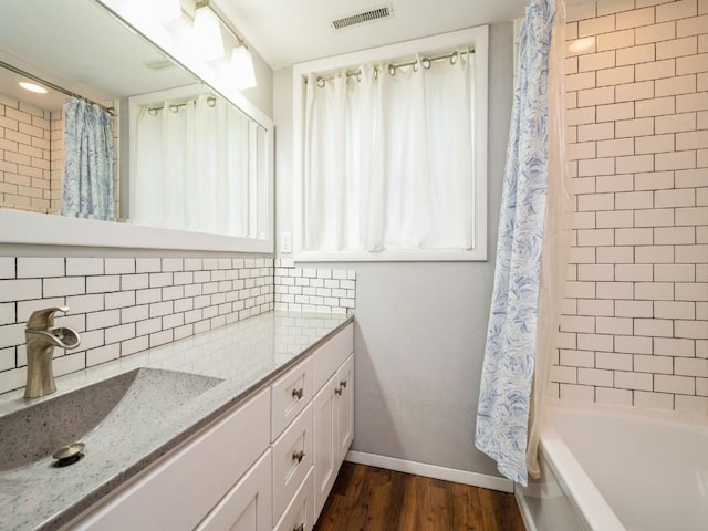 4721 Pine View Dr NE, Cedar Rapids, IA 52402 - bathroom featuring vanity, wood finished floors, baseboards, and tasteful backsplash