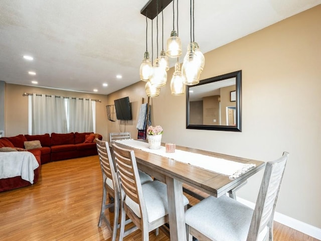 4721 Pine View Dr NE, Cedar Rapids, IA 52402 - dining space with light wood-style flooring, a chandelier, recessed lighting, and baseboards