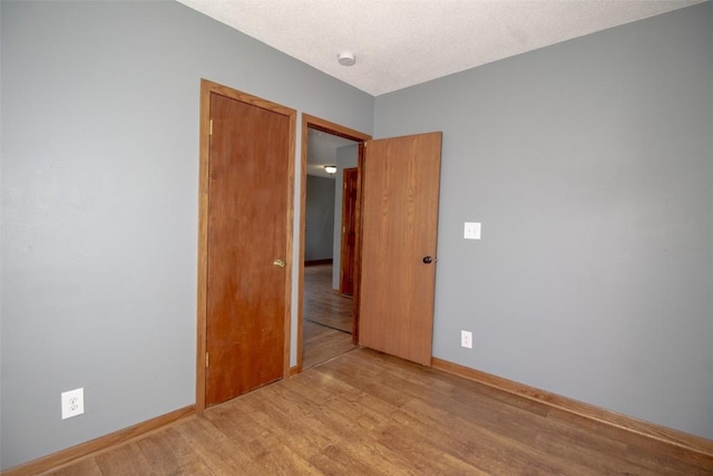 2339 Rompot St SE, Cedar Rapids, IA 52403 - unfurnished room featuring light wood-style floors, a smoke detector, and baseboards