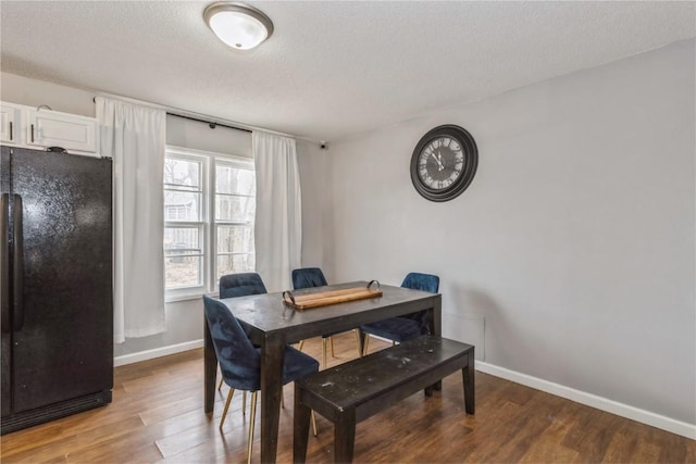 281 NW Jacolyn Dr, Cedar Rapids, IA 52405 - dining space with baseboards, wood finished floors, and a textured ceiling
