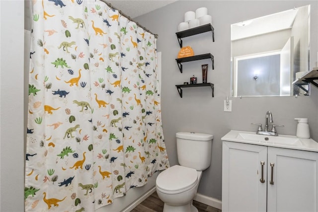 281 NW Jacolyn Dr, Cedar Rapids, IA 52405 - bathroom featuring vanity, toilet, wood finished floors, and baseboards
