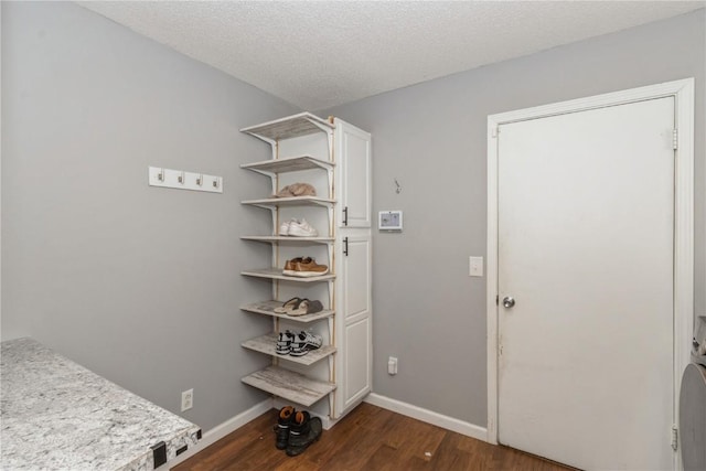 281 NW Jacolyn Dr, Cedar Rapids, IA 52405 - interior space with dark wood-style flooring, baseboards, and a textured ceiling