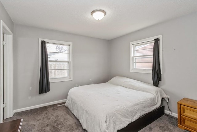 281 NW Jacolyn Dr, Cedar Rapids, IA 52405 - bedroom with multiple windows, carpet floors, baseboards, and a textured ceiling