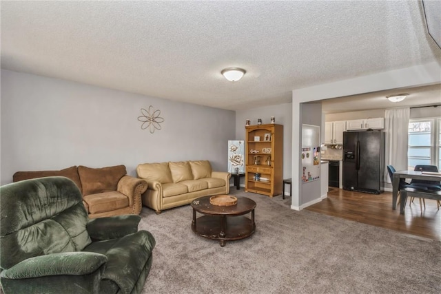 281 NW Jacolyn Dr, Cedar Rapids, IA 52405 - living area with dark colored carpet and a textured ceiling