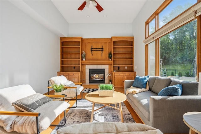 925 Rolling Creek Dr NE, Cedar Rapids, IA 52402 - living area featuring wood finished floors, ceiling fan, and a tiled fireplace