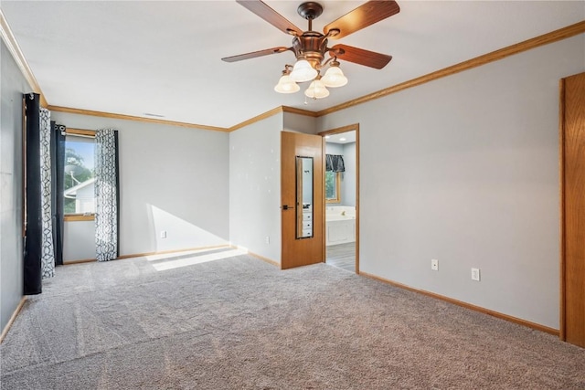 925 Rolling Creek Dr NE, Cedar Rapids, IA 52402 - spare room with crown molding, a ceiling fan, and carpet flooring