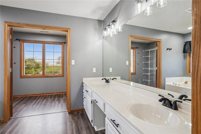 925 Rolling Creek Dr NE, Cedar Rapids, IA 52402 - full bathroom with wood finished floors, double vanity, and a bathtub