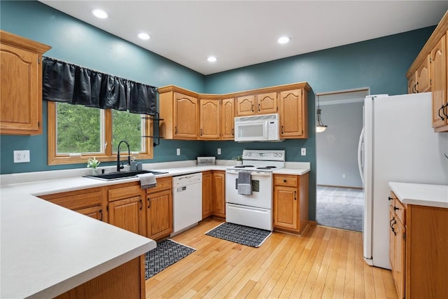 925 Rolling Creek Dr NE, Cedar Rapids, IA 52402 - kitchen with white appliances, light countertops, light wood-type flooring, recessed lighting, and brown cabinetry