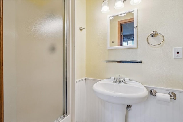 925 Rolling Creek Dr NE, Cedar Rapids, IA 52402 - full bathroom featuring a wainscoted wall and a shower stall