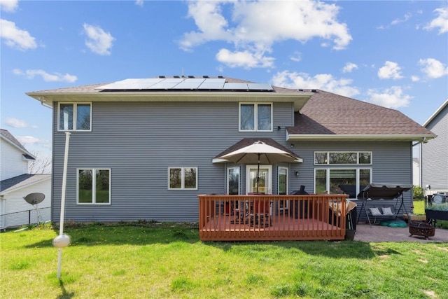 925 Rolling Creek Dr NE, Cedar Rapids, IA 52402 - back of house with roof mounted solar panels, a wooden deck, a hot tub, and a patio