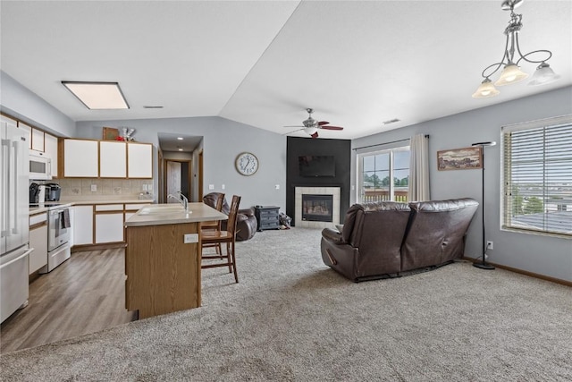 5525 Kacena Ave Unit 7, Marion, IA 52302 - kitchen with white appliances, ceiling fan, white cabinets, lofted ceiling, and light countertops