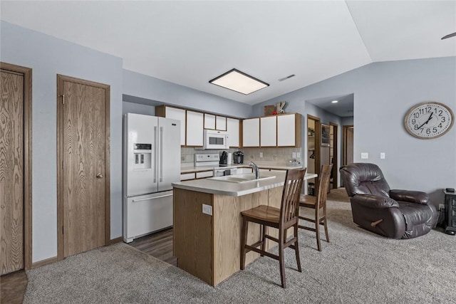 5525 Kacena Ave Unit 7, Marion, IA 52302 - kitchen with white appliances, carpet floors, lofted ceiling, open floor plan, and a sink