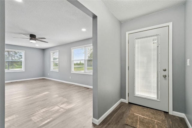 1626 High View Dr, Mount Vernon, IA 52314 - foyer entrance featuring dark wood-style flooring, baseboards, a ceiling fan, a textured ceiling, and recessed lighting