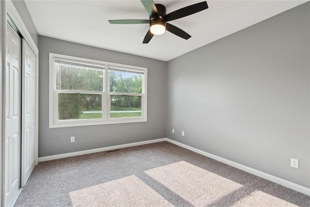 1626 High View Dr, Mount Vernon, IA 52314 - unfurnished bedroom featuring carpet flooring, baseboards, a closet, and ceiling fan