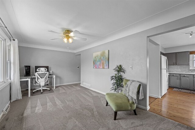 2043 Brookland Dr NE, Cedar Rapids, IA 52402 - office featuring ceiling fan, light carpet, and baseboards