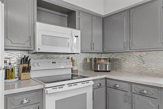 2043 Brookland Dr NE, Cedar Rapids, IA 52402 - kitchen with white appliances, gray cabinetry, and backsplash