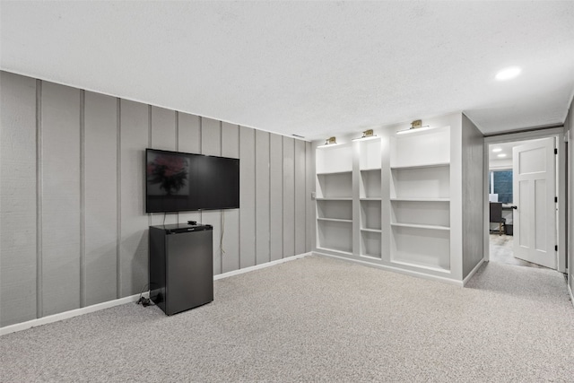 2043 Brookland Dr NE, Cedar Rapids, IA 52402 - unfurnished living room with carpet, baseboards, and a textured ceiling