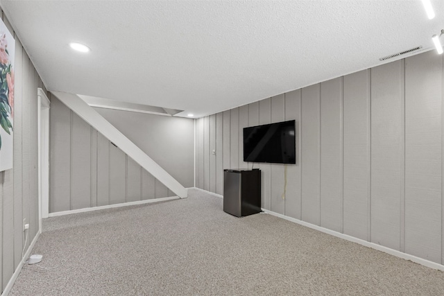2043 Brookland Dr NE, Cedar Rapids, IA 52402 - basement with carpet flooring, a decorative wall, and a textured ceiling