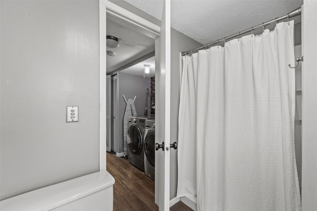 2043 Brookland Dr NE, Cedar Rapids, IA 52402 - bathroom featuring a textured ceiling, washer and clothes dryer, wood finished floors, toilet, and a shower with curtain