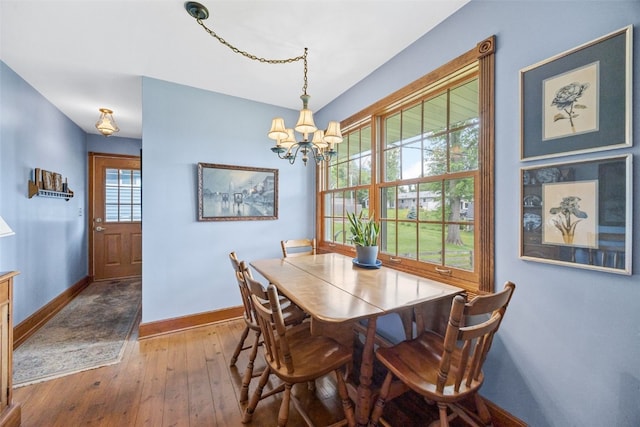 3009 Terry Dr SE, Cedar Rapids, IA 52403 - dining area with baseboards, a chandelier, and wood-type flooring