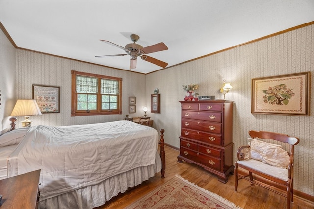 3009 Terry Dr SE, Cedar Rapids, IA 52403 - bedroom featuring crown molding, wood finished floors, wallpapered walls, and ceiling fan