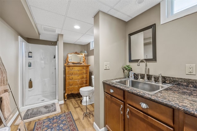 3009 Terry Dr SE, Cedar Rapids, IA 52403 - full bath featuring a paneled ceiling, wood finished floors, a stall shower, toilet, and vanity