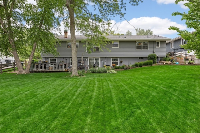 3009 Terry Dr SE, Cedar Rapids, IA 52403 - rear view of house with a yard, a chimney, and a wooden deck