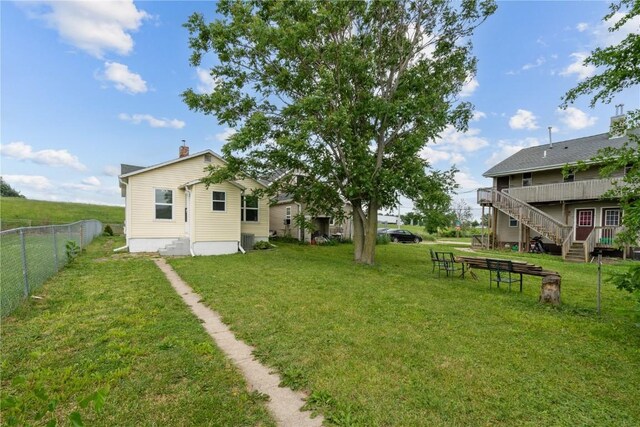 944 L St SW, Cedar Rapids, IA 52404 - view of yard with stairway, a deck, and central AC