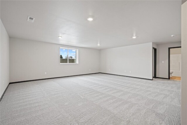 5017 Bluestem St SW, Kalona, IA 52247 - spare room with light colored carpet, baseboards, and recessed lighting