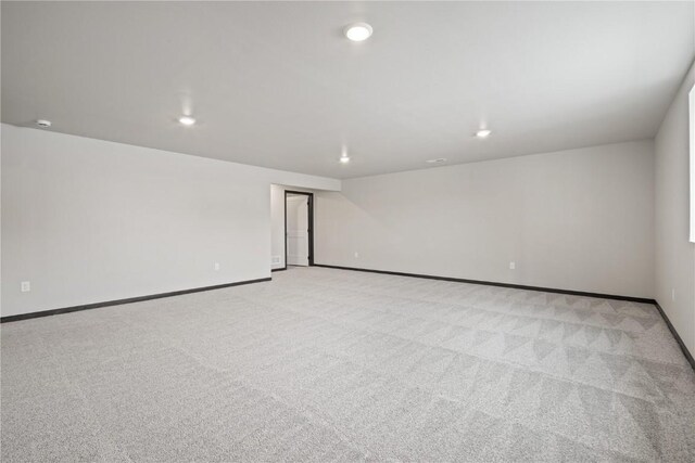 5017 Bluestem St SW, Kalona, IA 52247 - empty room with light colored carpet, baseboards, and recessed lighting