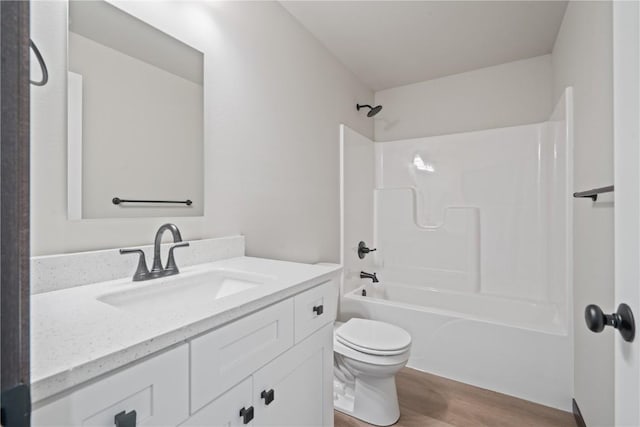 5017 Bluestem St SW, Kalona, IA 52247 - full bathroom with wood finished floors, toilet, vanity, and bathtub / shower combination