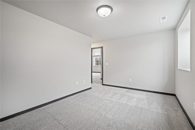 5017 Bluestem St SW, Kalona, IA 52247 - spare room with light carpet and baseboards
