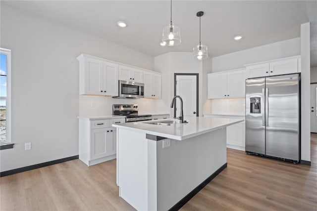 5017 Bluestem St SW, Kalona, IA 52247 - kitchen featuring stainless steel appliances, light wood-style floors, a sink, light countertops, and recessed lighting