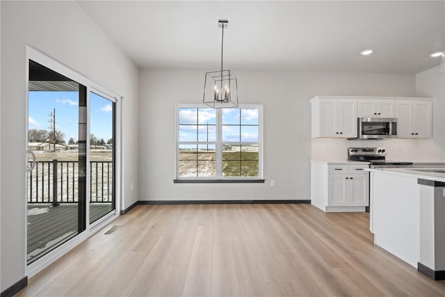 5017 Bluestem St SW, Kalona, IA 52247 - kitchen featuring stainless steel appliances, light wood-style flooring, a chandelier, white cabinetry, and recessed lighting