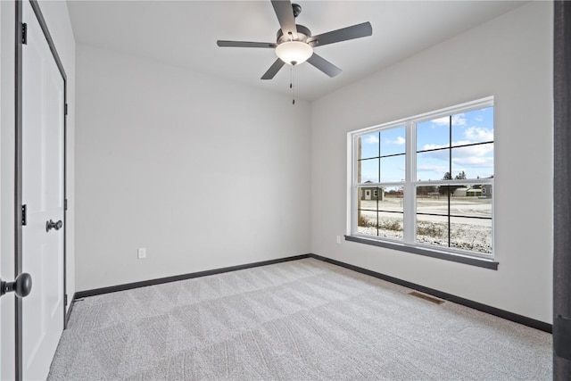 5017 Bluestem St SW, Kalona, IA 52247 - unfurnished bedroom with light colored carpet, baseboards, and ceiling fan