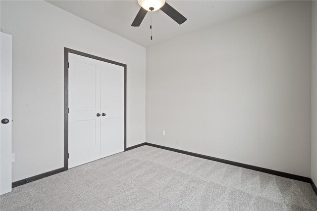 5017 Bluestem St SW, Kalona, IA 52247 - unfurnished bedroom featuring carpet floors, a closet, baseboards, and ceiling fan
