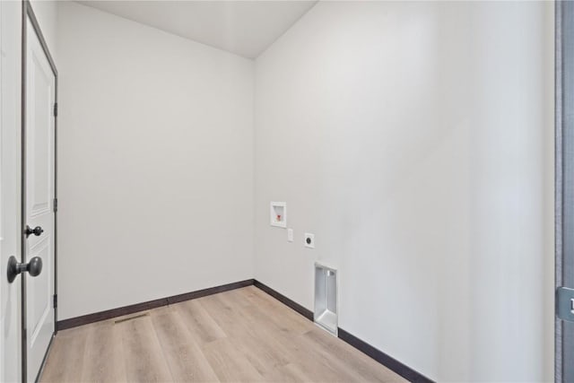 5017 Bluestem St SW, Kalona, IA 52247 - laundry room featuring hookup for an electric dryer, hookup for a washing machine, light wood finished floors, and baseboards