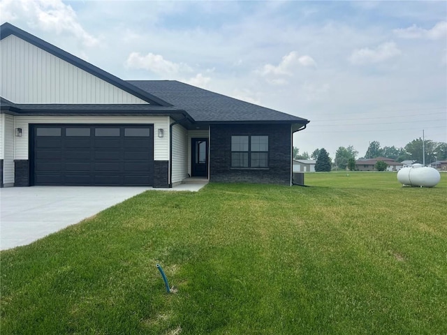 5017 Bluestem St SW, Kalona, IA 52247 - view of front of house featuring an attached garage, concrete driveway, and a front lawn