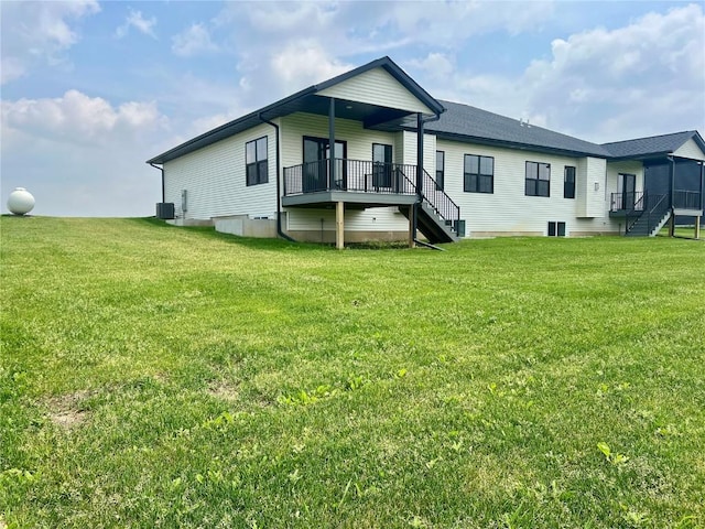5017 Bluestem St SW, Kalona, IA 52247 - rear view of house with a lawn and a wooden deck