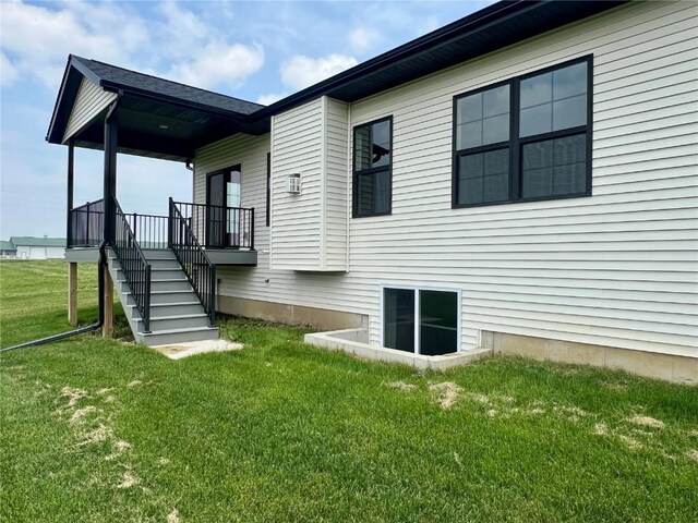 5017 Bluestem St SW, Kalona, IA 52247 - rear view of house with a yard and stairway