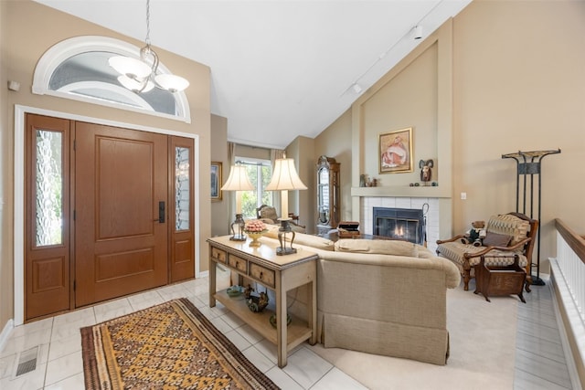 13 S View Dr NE, Iowa City, IA 52240 - foyer featuring high vaulted ceiling, a chandelier, a tile fireplace, and baseboards