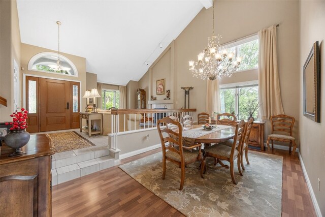13 S View Dr NE, Iowa City, IA 52240 - dining space featuring high vaulted ceiling, a chandelier, wood finished floors, and healthy amount of natural light