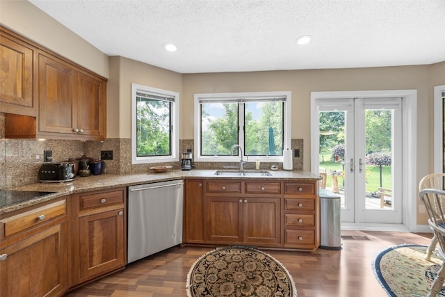 13 S View Dr NE, Iowa City, IA 52240 - kitchen featuring stainless steel dishwasher, a sink, brown cabinets, dark wood finished floors, and healthy amount of natural light