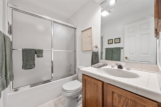 13 S View Dr NE, Iowa City, IA 52240 - full bath with vanity, toilet, enclosed tub / shower combo, and tile patterned flooring