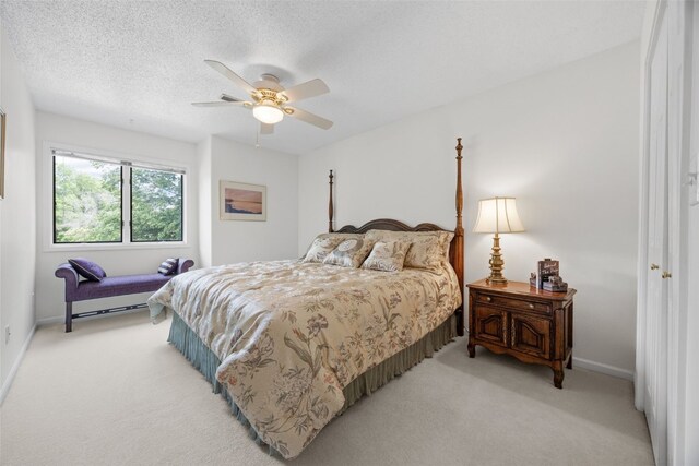 13 S View Dr NE, Iowa City, IA 52240 - bedroom featuring light colored carpet, baseboards, a ceiling fan, and a textured ceiling