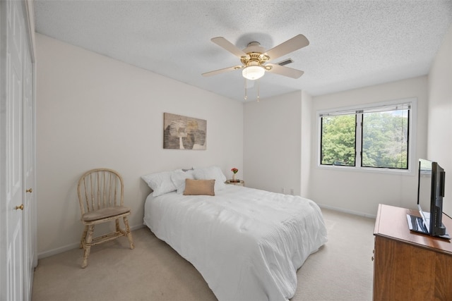 13 S View Dr NE, Iowa City, IA 52240 - bedroom with light carpet, baseboards, a textured ceiling, and ceiling fan