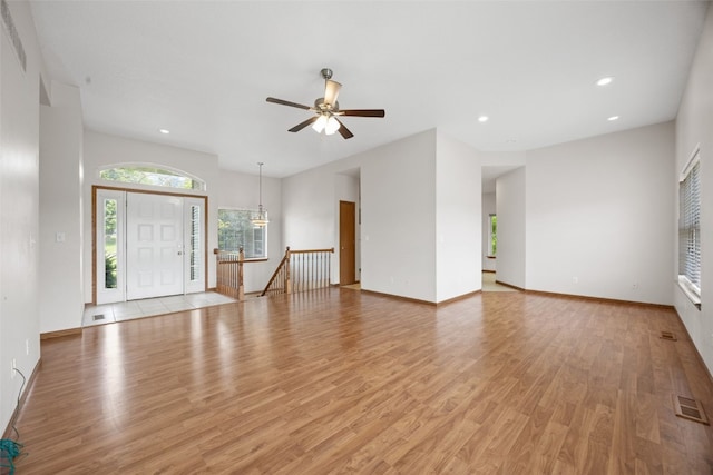 3017 Peaceful Dr, Riverside, IA 52327 - unfurnished living room with light wood finished floors, ceiling fan, recessed lighting, and baseboards