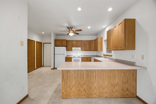 3017 Peaceful Dr, Riverside, IA 52327 - kitchen with white appliances, a sink, under cabinet range hood, a peninsula, and recessed lighting