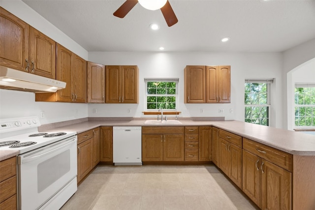3017 Peaceful Dr, Riverside, IA 52327 - kitchen featuring white appliances, a sink, under cabinet range hood, plenty of natural light, and recessed lighting