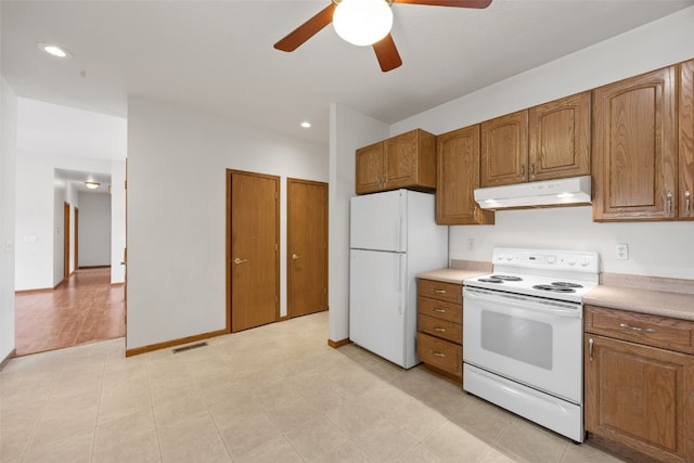 3017 Peaceful Dr, Riverside, IA 52327 - kitchen featuring white appliances, under cabinet range hood, a ceiling fan, brown cabinets, and recessed lighting